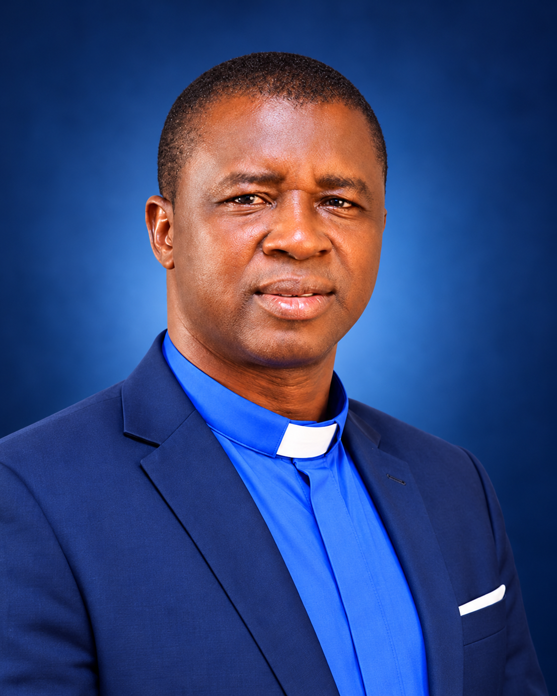 Rev. Isaac Naanpukin Kombat in a navy suit and blue clerical shirt